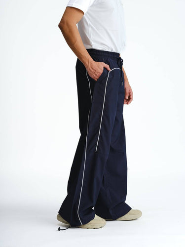 Navy blue sporty deconstructed loose pants by Bonkers Corner, featuring relaxed fit and casual style, shown on a model.