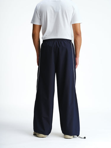 Navy blue sporty deconstructed loose pants by Bonkers Corner, relaxed fit with casual, athletic style and waistband details.