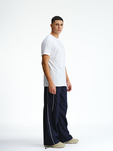 Navy blue sporty deconstructed loose pants by Bonkers Corner, relaxed fit with casual style, shown on a white background.