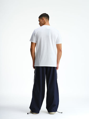 Navy blue sporty deconstructed loose pants by Bonkers Corner, featuring relaxed fit and casual style.