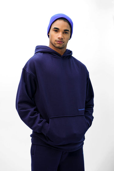 Navy blue Wear A Hug oversized hoodie by Bonkers Corner, featuring a relaxed fit and soft fabric, shown on a model.