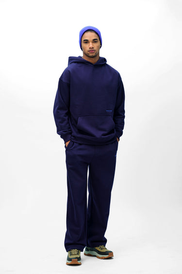 Navy blue Wear A Hug oversized hoodie by Bonkers Corner, featuring a relaxed fit and soft fabric, shown on a model.