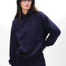 Navy blue oversized hoodie by Bonkers Corner with "Wear A Hug" graphic, relaxed fit, soft fabric, and casual style.