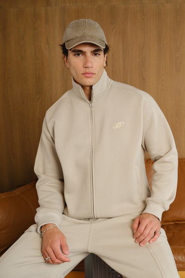 Bonkers Corner Oatmilk High Neck Zipper Jacket shown in XS with a high collar and front zipper detail.