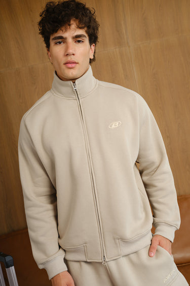 Bonkers Corner Oatmilk high neck zipper jacket showing a fitted, stylish design with a front zipper and high collar.