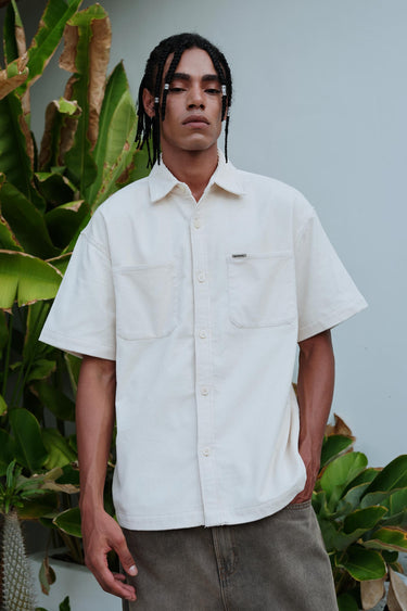 Off White Corduroy Shirt by Bonkers Corner, featuring a classic collar and textured fabric, shown in a close-up view of the shirt's fabric and design.