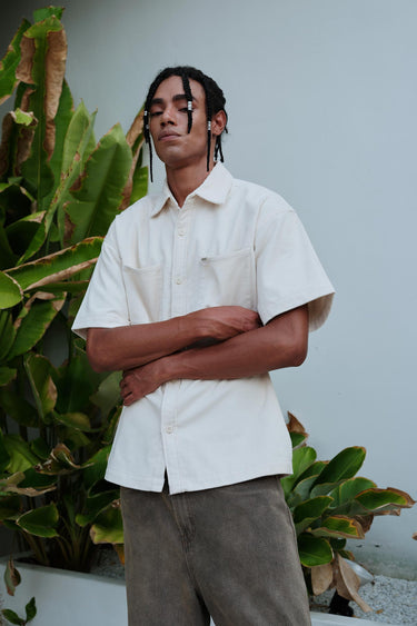 Bonkers Corner off-white corduroy shirt displayed on a hanger, featuring a classic collar and textured fabric.