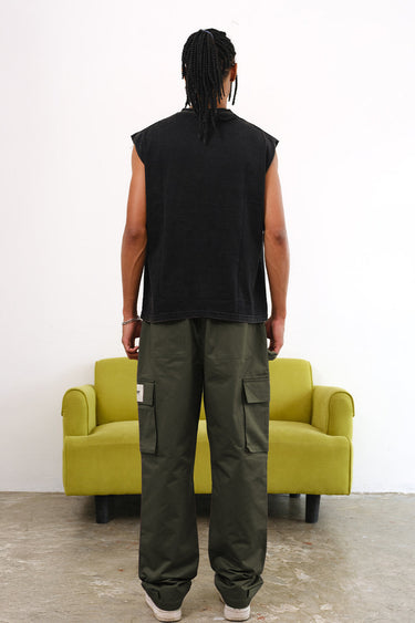 Olive cargo pants with utility pockets by Bonkers Corner, featuring a relaxed fit and functional side and back pockets.