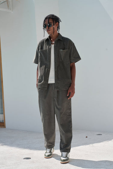 Olive green corduroy pants by Bonkers Corner featuring a slim fit and textured fabric.