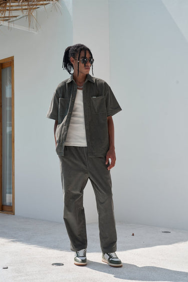 Bonkers Corner olive corduroy pants with a relaxed fit, featuring textured fabric and classic five-pocket design.