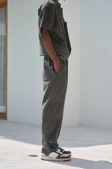 Olive green corduroy pants from Bonkers Corner, slim-fit with textured fabric and classic five-pocket design.