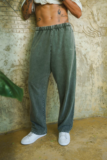 Olive faded loose-fit pants by Bonkers Corner displayed on a model, featuring relaxed style and comfortable fit.