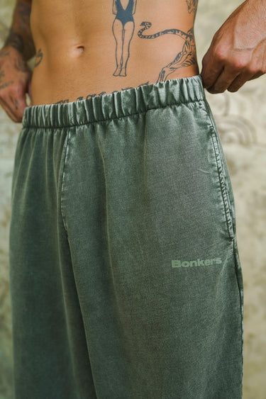 Olive faded loose-fit pants from Bonkers Corner with relaxed style and casual fit, shown on a model.