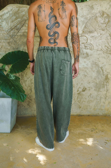 Bonkers Corner olive faded loose-fit pants displayed on a model, featuring relaxed fit and casual style.