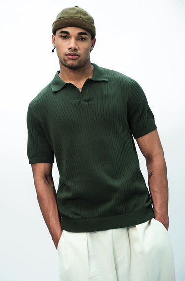 Olive green knit polo T-shirt by Bonkers Corner, close-up of fabric and collar showing casual style and textured knit material.
