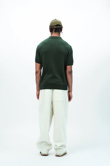 Olive green knit polo T-shirt by Bonkers Corner, featuring a classic collar and short sleeves, displayed on a plain background.