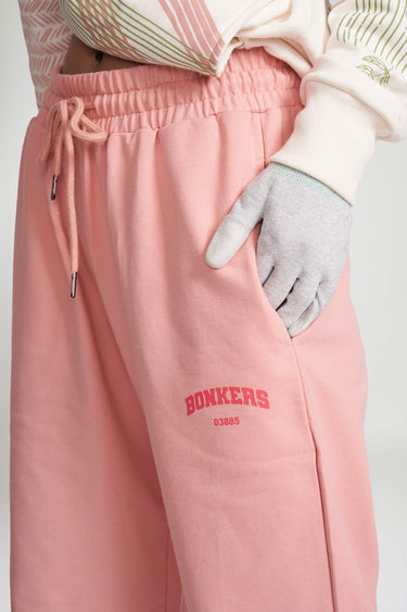 Peach pink wide-leg sweatpants from Bonkers Corner, casual fit with elastic waistband and relaxed style.