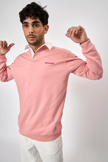 Pink collared sweatshirt from Bonkers Corner, featuring a soft fabric, ribbed cuffs, and a casual, relaxed fit.