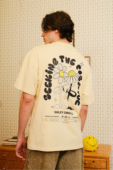 Light blue oversized T-shirt from Bonkers Corner featuring "Seeking The Positive" graphic design. Casual and comfortable fit.