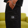 Bonkers Corner Signature Black Utility Shorts displayed on a model, featuring multiple pockets and a relaxed fit.