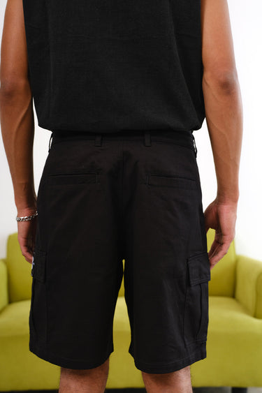 Bonkers Corner Signature Black Utility Shorts displayed on a model, featuring multiple pockets and a casual fit.