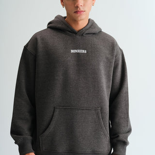 Bonkers Corner Signature Dark Grey Melange Hoodie shown on a hanger, featuring a soft fabric and casual fit.