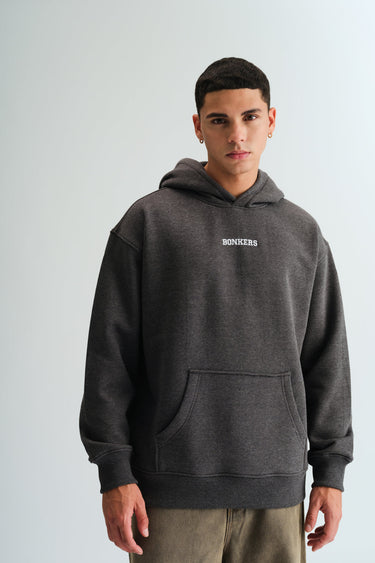 Dark grey melange hoodie from Bonkers Corner, featuring a relaxed fit and soft fabric, displayed on a hanger.