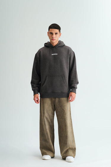 Dark grey melange hoodie from Bonkers Corner featuring a relaxed fit and soft fabric, shown on a model.