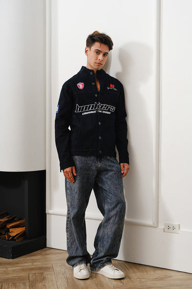Bonkers Corner Signature Denim Jacket displayed on a hanger, showcasing classic blue denim with button front and stylish fit.