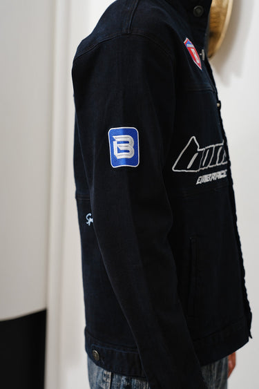 Bonkers Corner Signature Denim Jacket displayed on a hanger, showcasing classic blue denim with stitching details.