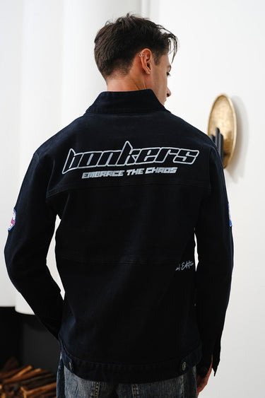 Bonkers Corner Signature Denim Jacket displayed on a hanger, showcasing classic blue denim and stylish design.
