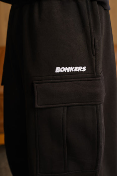 Bonkers Corner Stealth Black 4 Pocket Pant showing front view with four functional pockets and sleek black fabric.