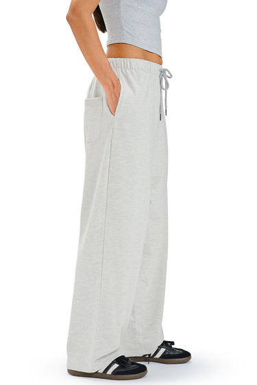 Light gray Studio Mist loose fit joggers from Bonkers Corner shown on a model, featuring a relaxed silhouette and elastic waistband.