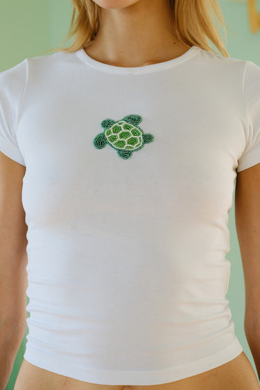 Baby tee by Bonkers Corner with colorful beaded embroidery and turtleneck design, featuring playful, vibrant details.