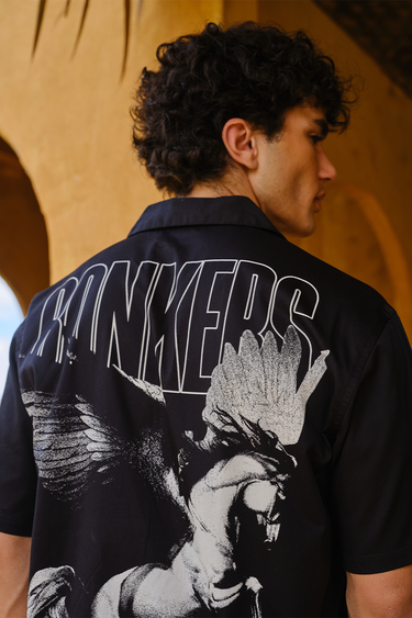 Bonkers Corner Warrior Alicorn oversized shirt showing a colorful unicorn with armor design on soft fabric.
