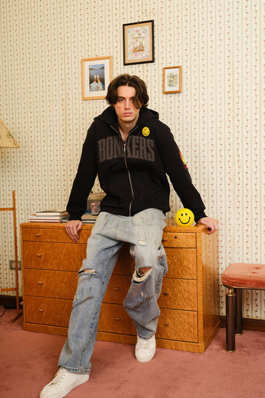 Bonkers Corner We Are All Originals zipper jacket in XS displayed on a hanger with a front view and full design visible.