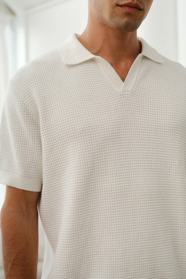 White knit polo T-shirt by Bonkers Corner, featuring a classic collar and short sleeves, displayed on a hanger.