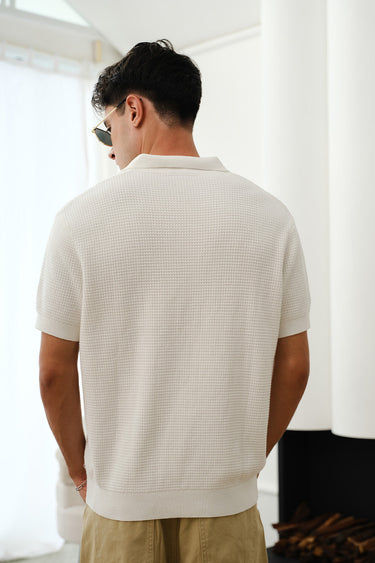 White knit polo T-shirt by Bonkers Corner, close-up of fabric and collar detail on a casual men's shirt.
