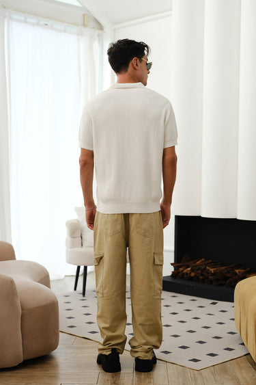 White knit polo T-shirt by Bonkers Corner featuring a classic collar and short sleeves, displayed flat on a white background.
