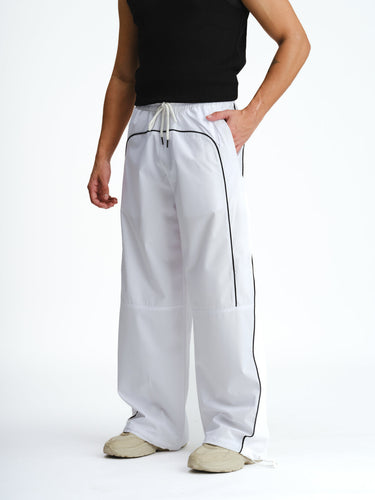 White sporty deconstructed loose pants by Bonkers Corner, featuring relaxed fit and stylish design.