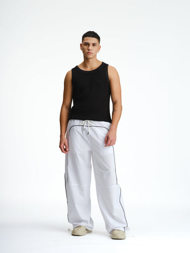 White sporty deconstructed loose pants from Bonkers Corner, featuring a relaxed fit and casual style.