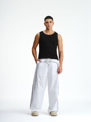 White sporty deconstructed loose pants by Bonkers Corner, relaxed fit with casual style, shown on a model.