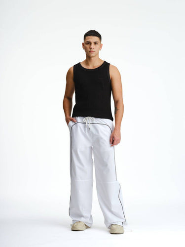 White sporty deconstructed loose pants by Bonkers Corner, relaxed fit with casual style, shown on a model.