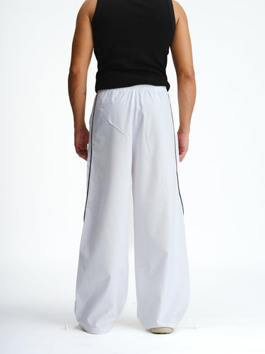 White sporty deconstructed loose pants by Bonkers Corner, featuring a relaxed fit and casual style.