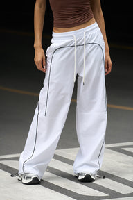 White sporty deconstructed loose pants from Bonkers Corner with a relaxed fit and casual style.