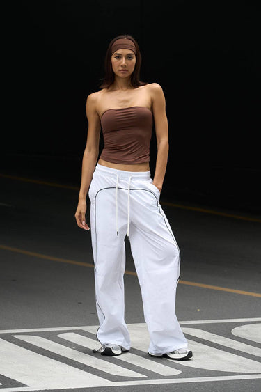 White sporty deconstructed loose pants by Bonkers Corner, relaxed fit with stylish, casual design and comfortable fabric.