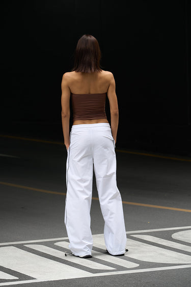 White sporty deconstructed loose pants from Bonkers Corner, featuring a relaxed fit and casual style.