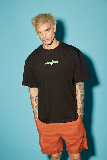 Bonkers Corner oversized T-shirt featuring the "Humans Aren't Real" graphic in black, styled casually on a model.