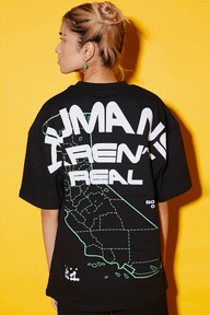 Bonkers Corner oversized T-shirt featuring bold "Humans Aren't Real" graphic design in black and white.