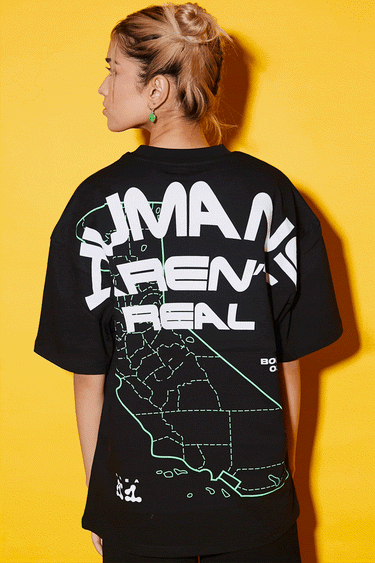 Bonkers Corner oversized T-shirt featuring bold "Humans Aren't Real" graphic design in black and white.